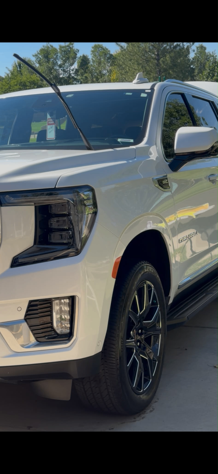White GMC Yukon Denali detailed outdoors